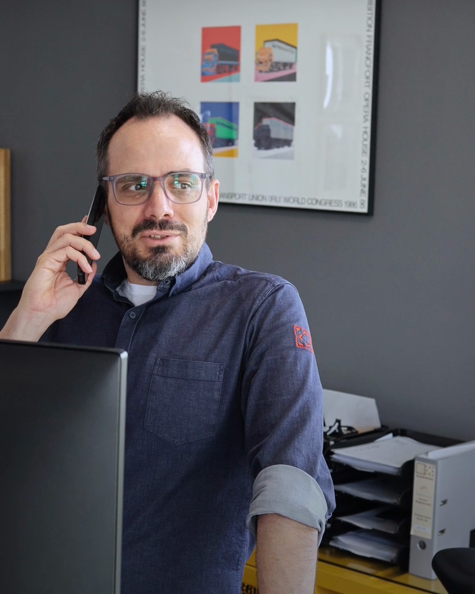 Mitarbeiter von Schlimgen Logistics telefoniert an seinem Arbeitsplatz im Büro